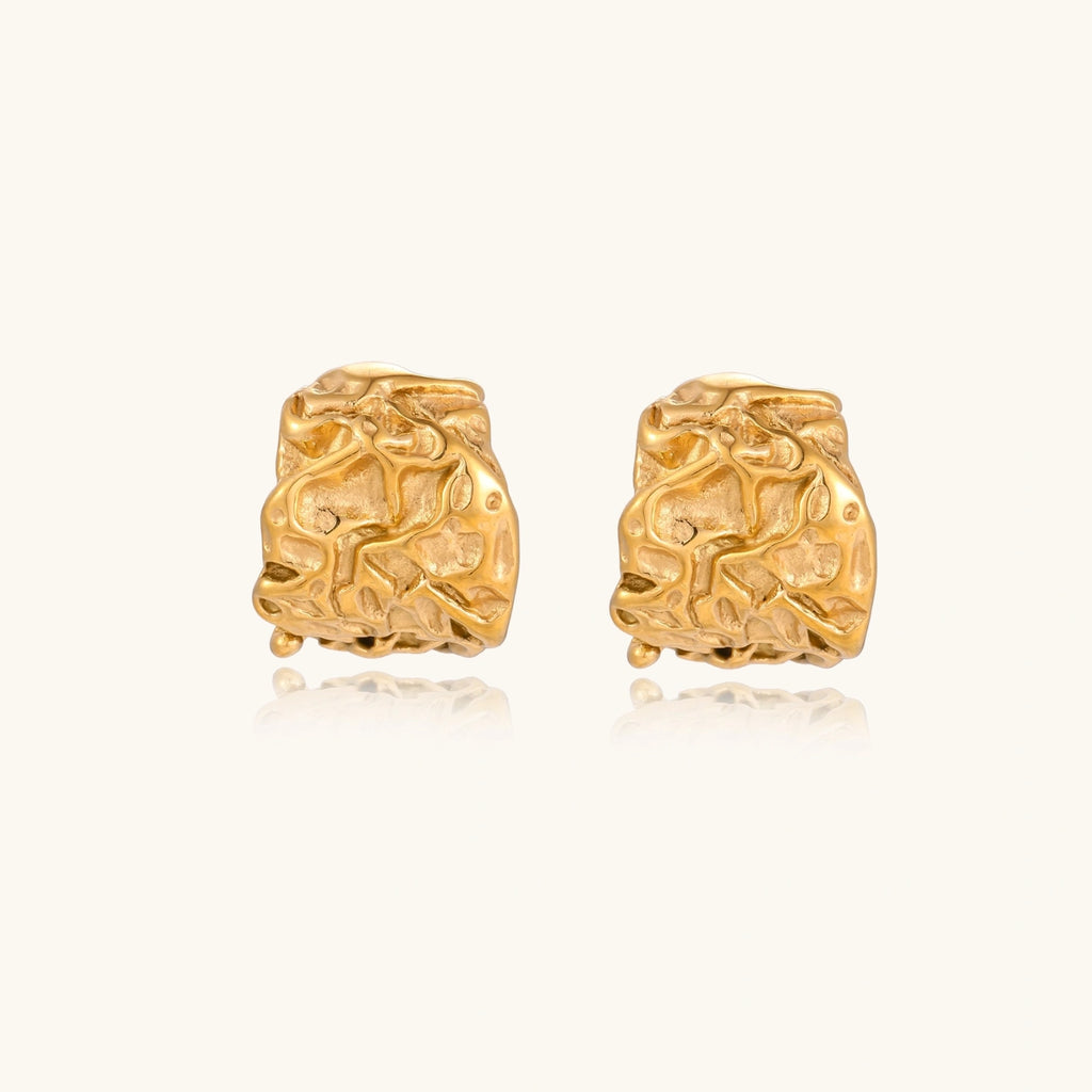 Chunky gold-plated hoop earrings with organic crumpled texture on cream background, 21.5mm sculptural design